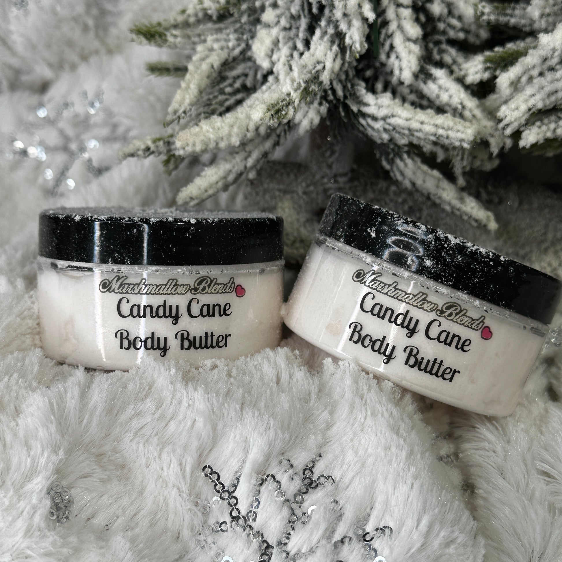 Clear tub of whipped white body butter, with snowy escape backdrop